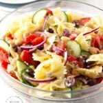 MEDITERRANEAN PASTA SALAD with bowtie pasta, red onion, cucumbers, cherry tomatoes, chick peas and feta cheese in a lemony vinaigrette #pastasalad #summer #sidedish #healthysidedish #happilyunprocessed