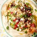 LAYERED HUMMUS DIP - Homemeade Hummus topped with Kalamata olives, cucumbers, roasted red peppers, feta cheese and pine nuts #hummus #healthy #chickpeas #tahini #happilyunprocessed