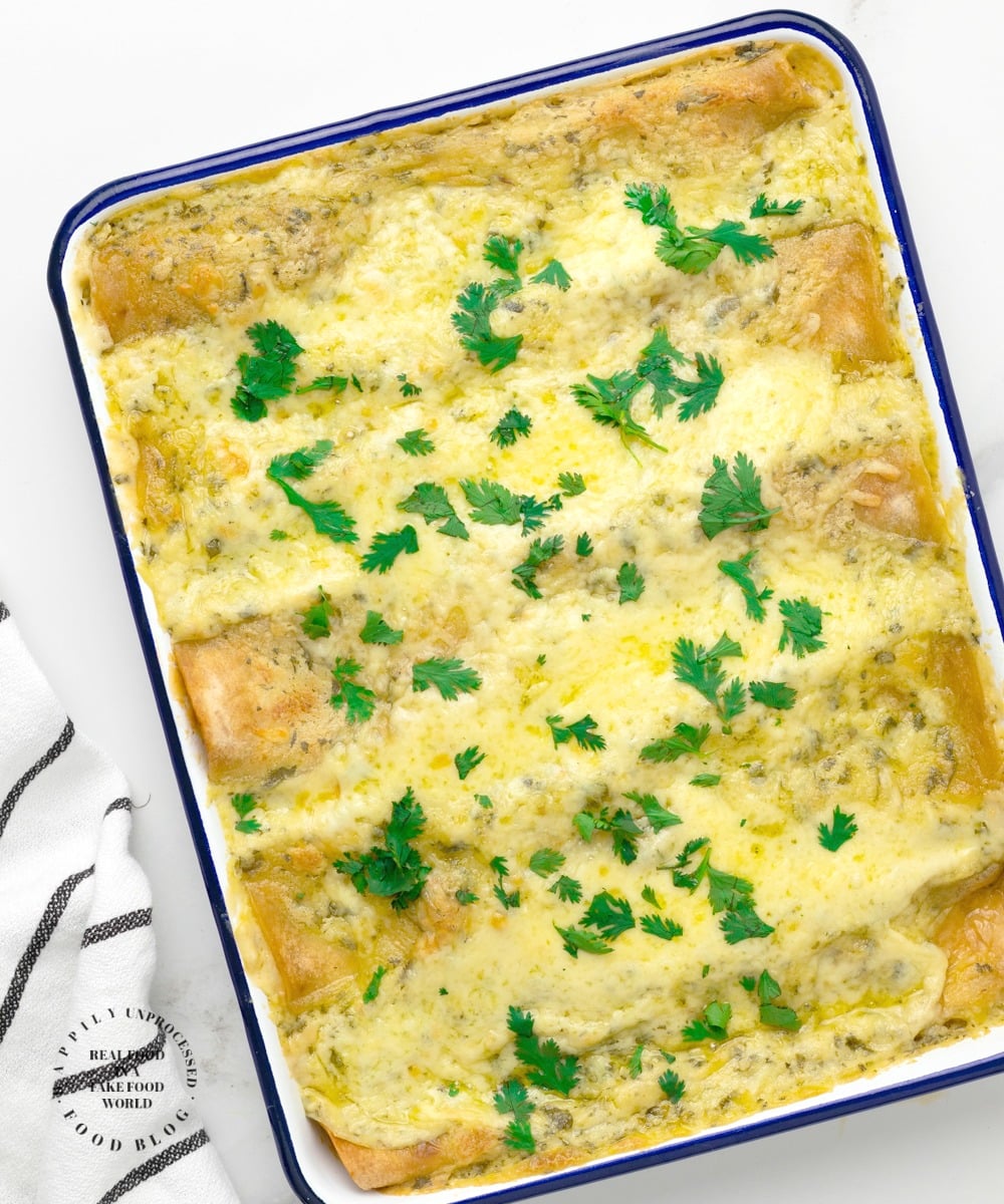 CREAMY SHRIMP ENCHILADAS - succulent shrimp inside an enchilada topped with a creamy cheesy sauce #seafood #shrimp #enchilada #happilyunprocessed