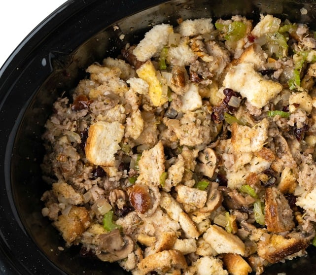 Slow cooker stuffing with sausage, cranberries, herbs and pecans. No turkey needed! The slow cooker makes the moistest best stuffing ever! #stuffing #thanksgiving #thanksgiving side dish # turkey #side dish