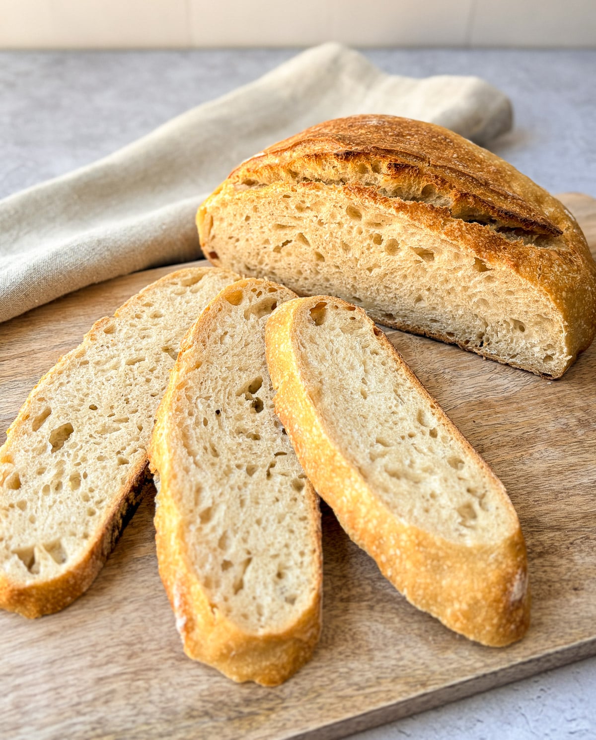 Sourdough bread loaf and slices on a cutting board